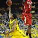 Michigan sophomore Trey Burke attempts a shot and misses from under the net and around North Carolina State junior C.J. Leslie during the second half at Crisler Center on Tuesday night. Melanie Maxwell I AnnArbor.com